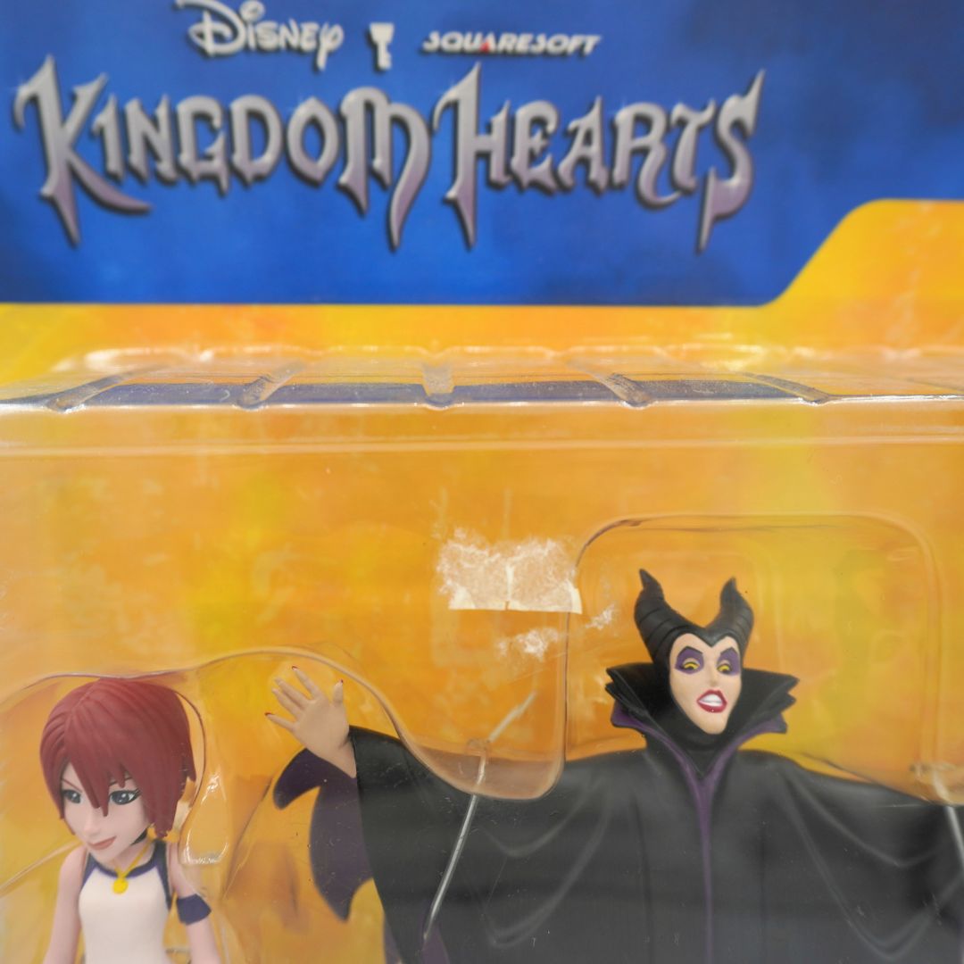 Disney Kingdom Hearts figure of Maleficent in its original blister packaging, featuring the Disney and Squaresoft logos at the top and a yellow-orange background.