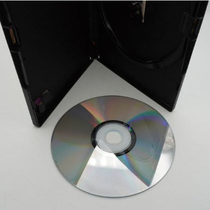CD/DVD on a white surface with a black case in the background