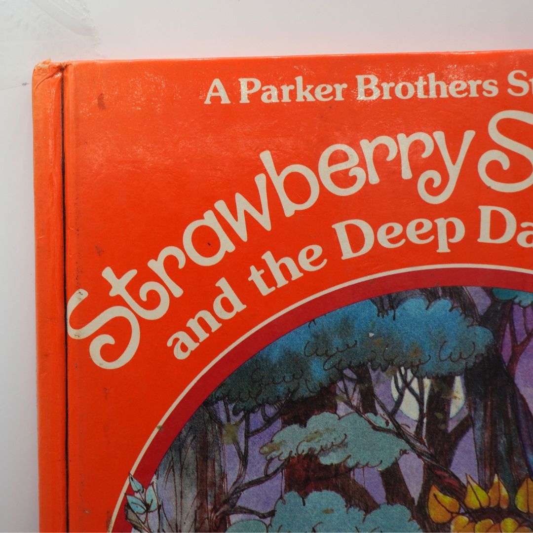 Vintage Strawberry Shortcake orange book cover with a damaged corner