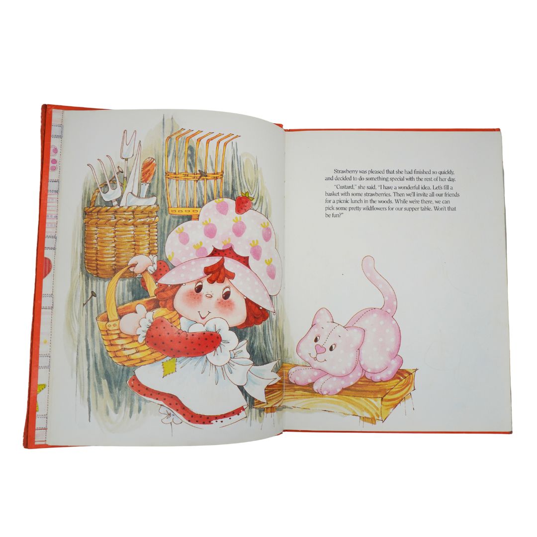 Open book with illustrations of a girl and a cat on a white background