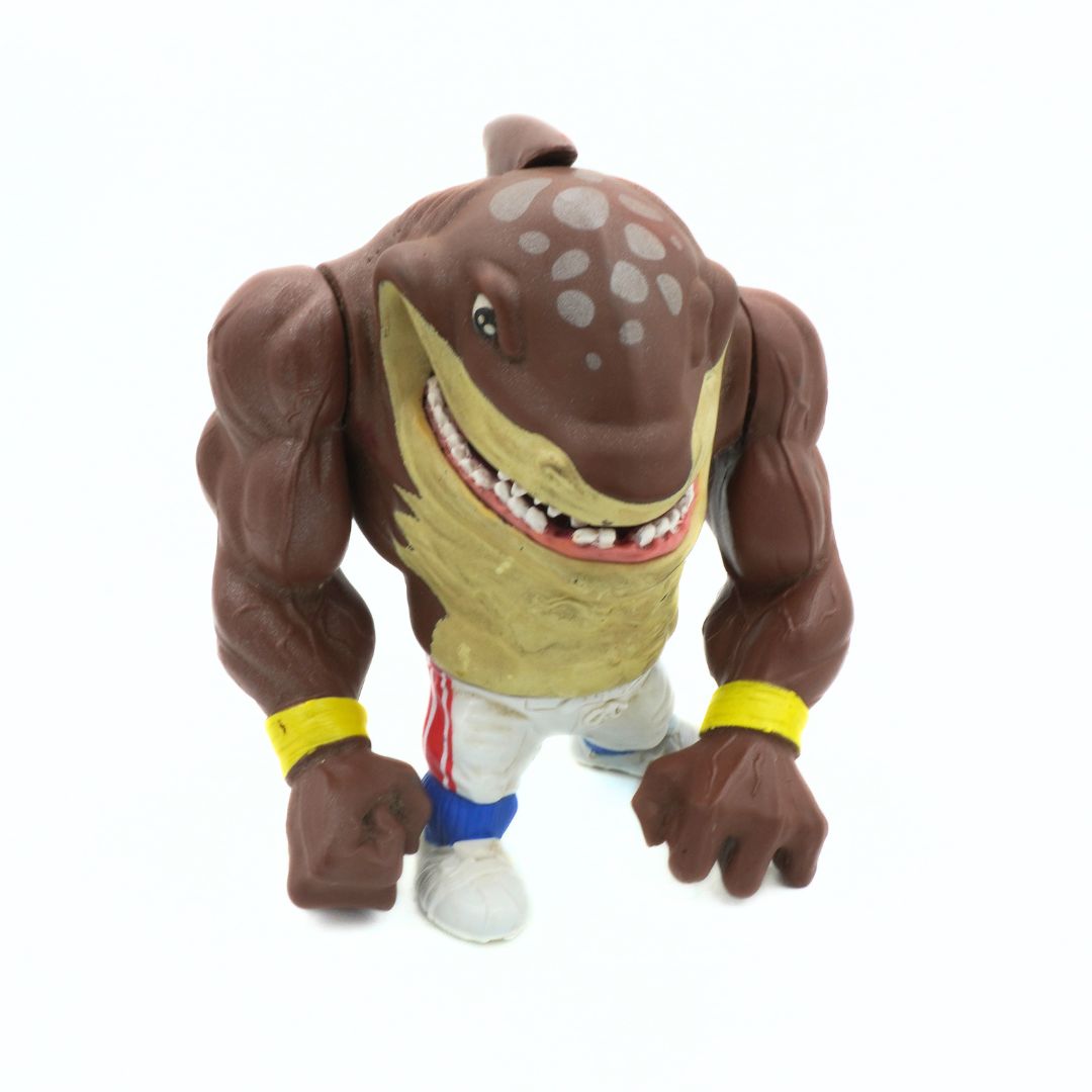 Toy figure of a muscular shark with a white background