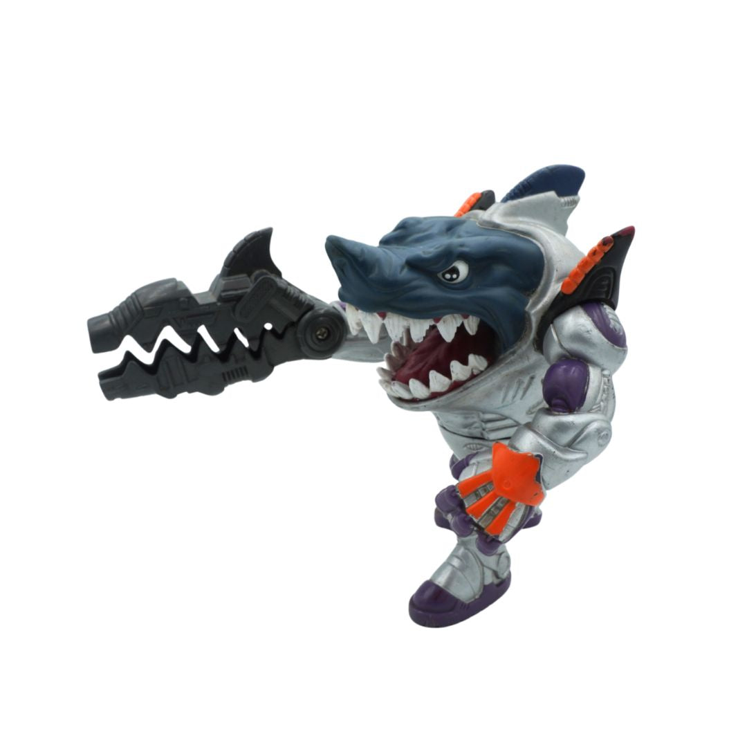 Toy figure of a shark-like character holding a weapon on a white background