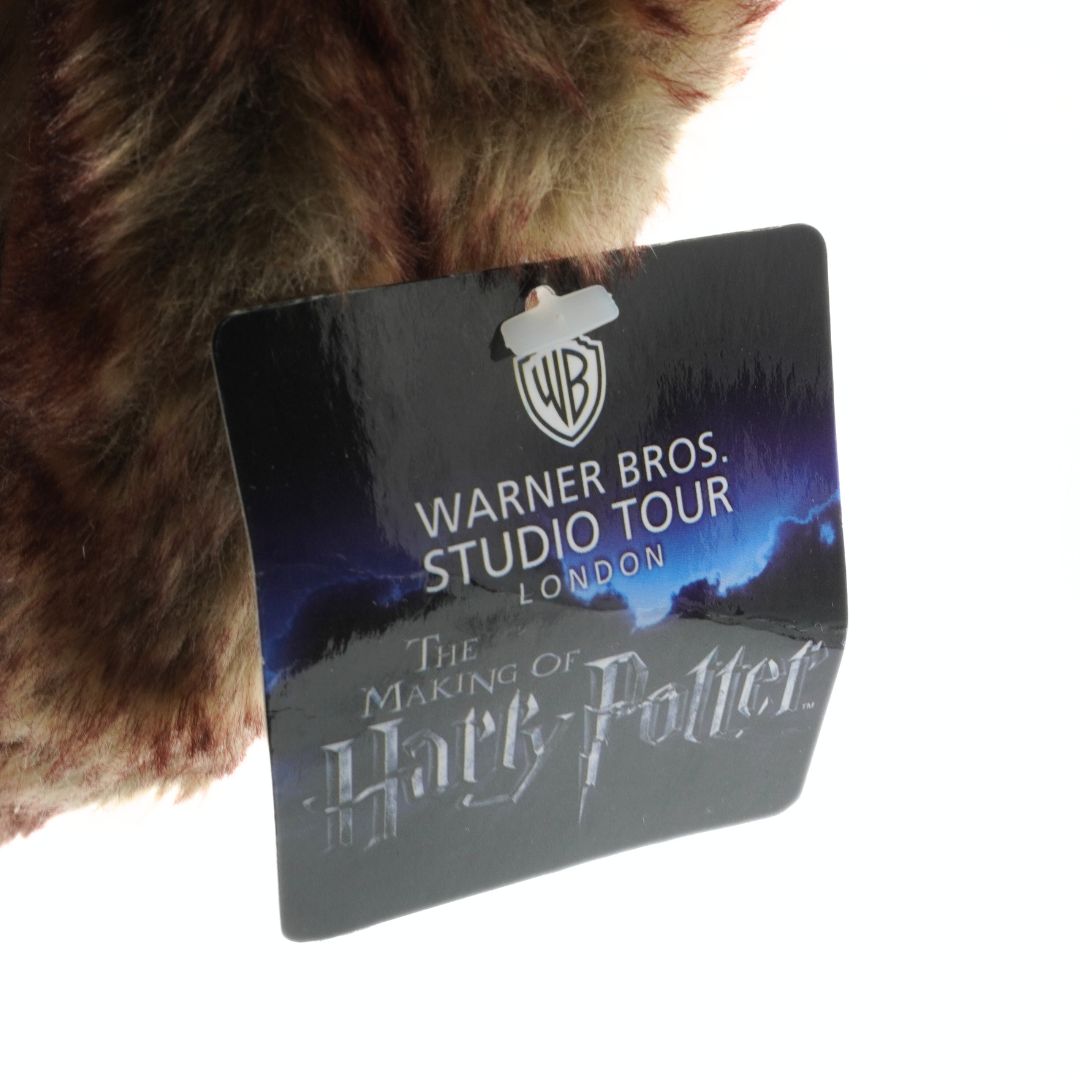 Hairy creature with a Warner Bros. Studio Tour London tag on a white background