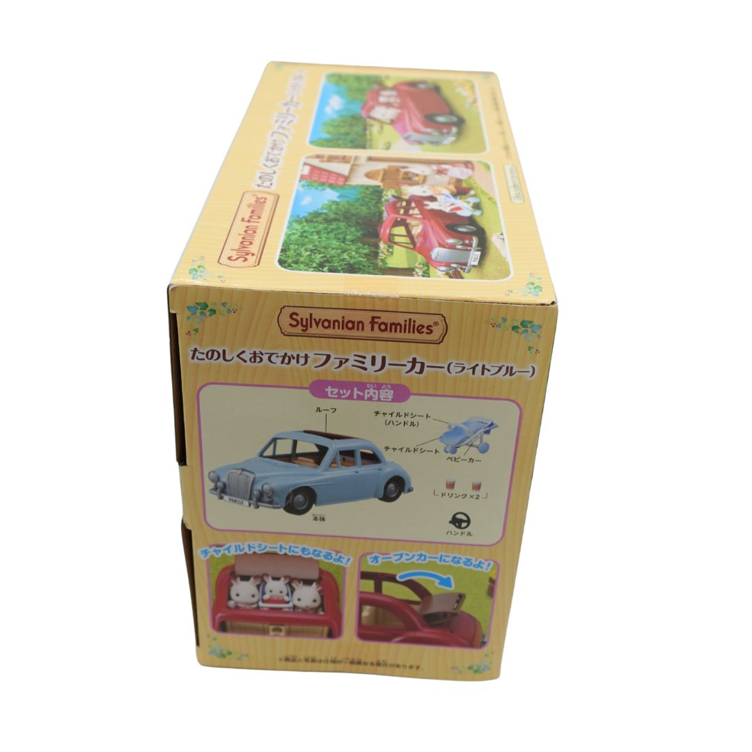 Sylvanian Families toy car set in its original Japanese packaging, featuring a light blue family car with animal passengers.