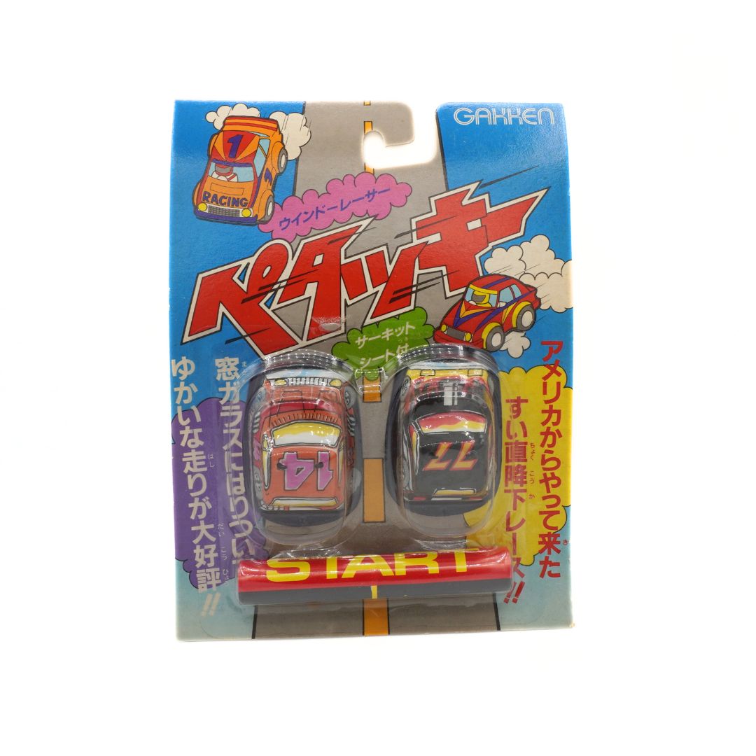 Toy car packaging with colorful design and text on a white background