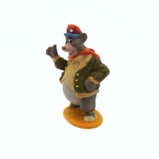 Animated character figurine in a green coat and red hat on a white background