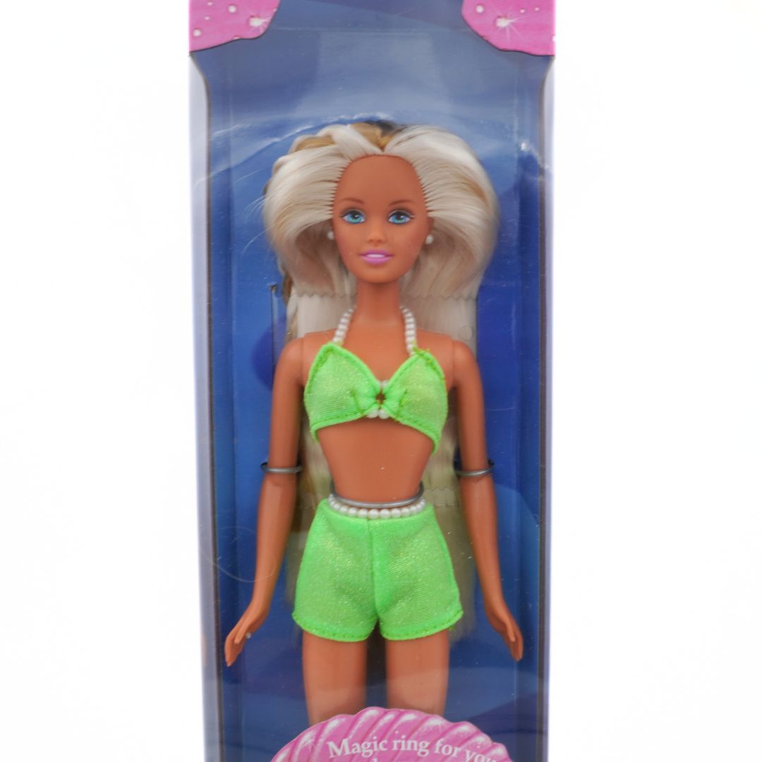 Barbie doll in green bikini and shorts with packaging