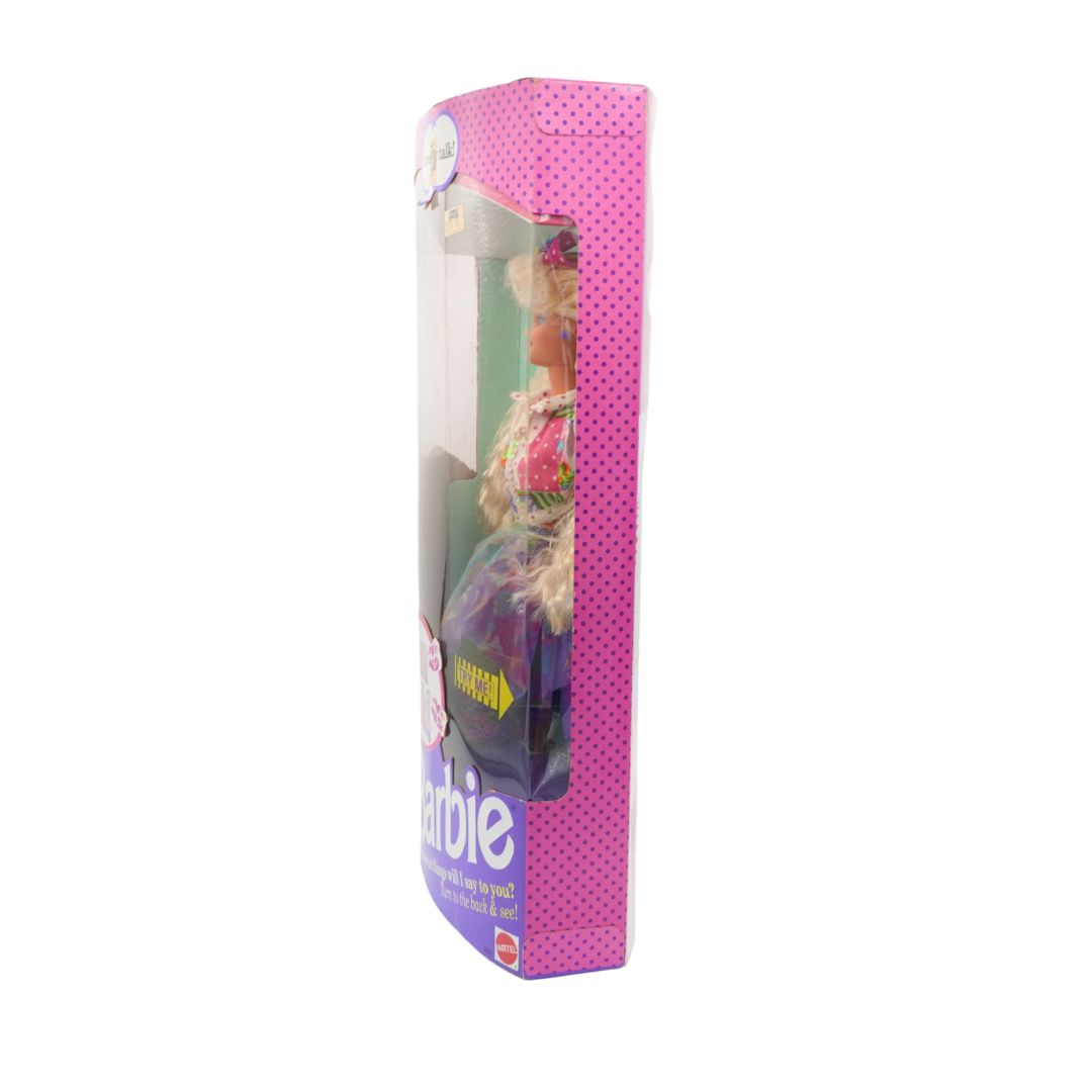 Barbie doll in a pink packaging box on a white background