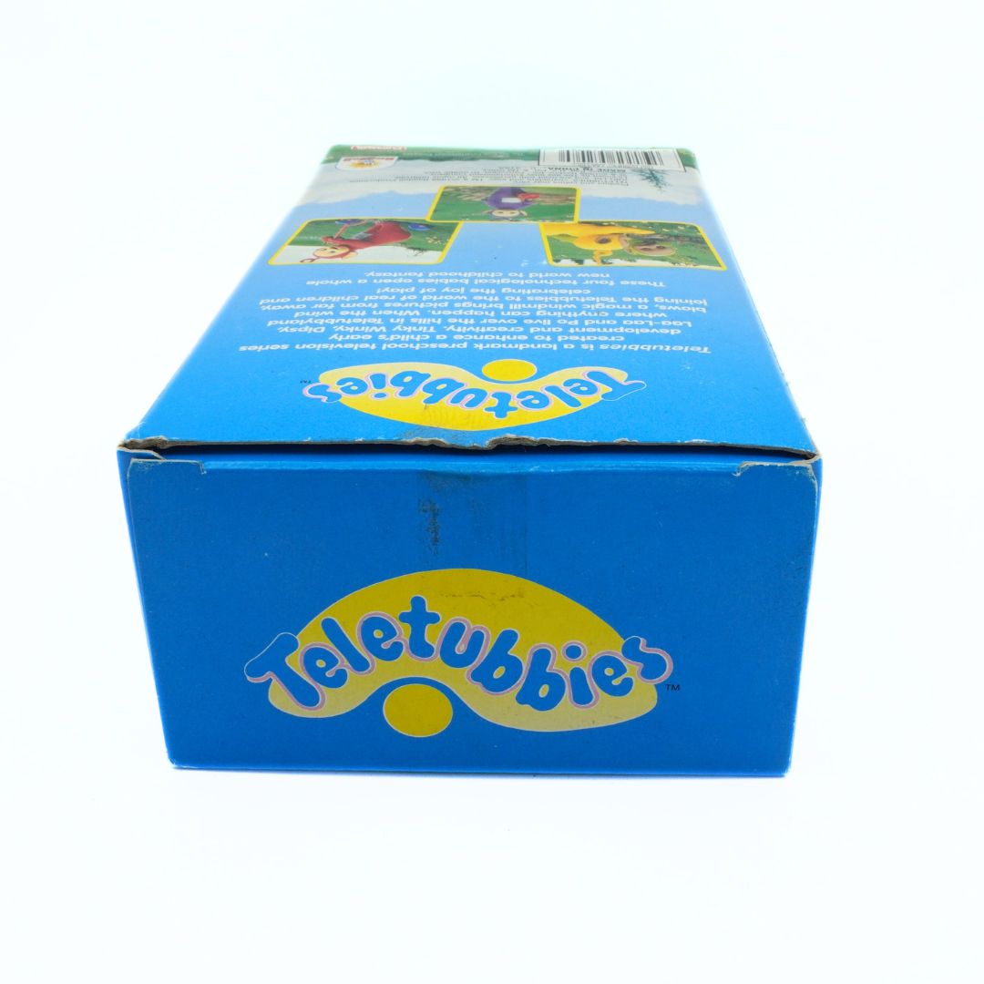 Top down angle of a boxed Teletubbies toy showing some wear