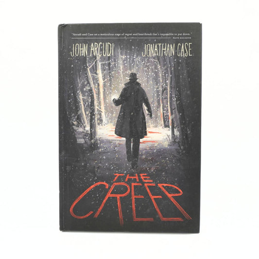 The Creep book by John Arcudi and Jonathan Case, featuring a dark cover illustration of a figure walking through a snowy forest at night with red title text, shown on a plain white background.