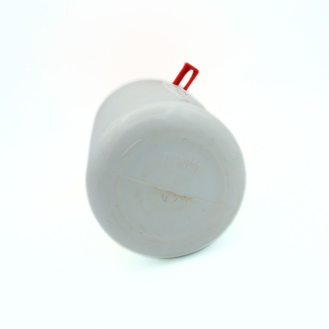 Underside of a vintage Mattel 1990 Barbie Thermos showing some discolouration