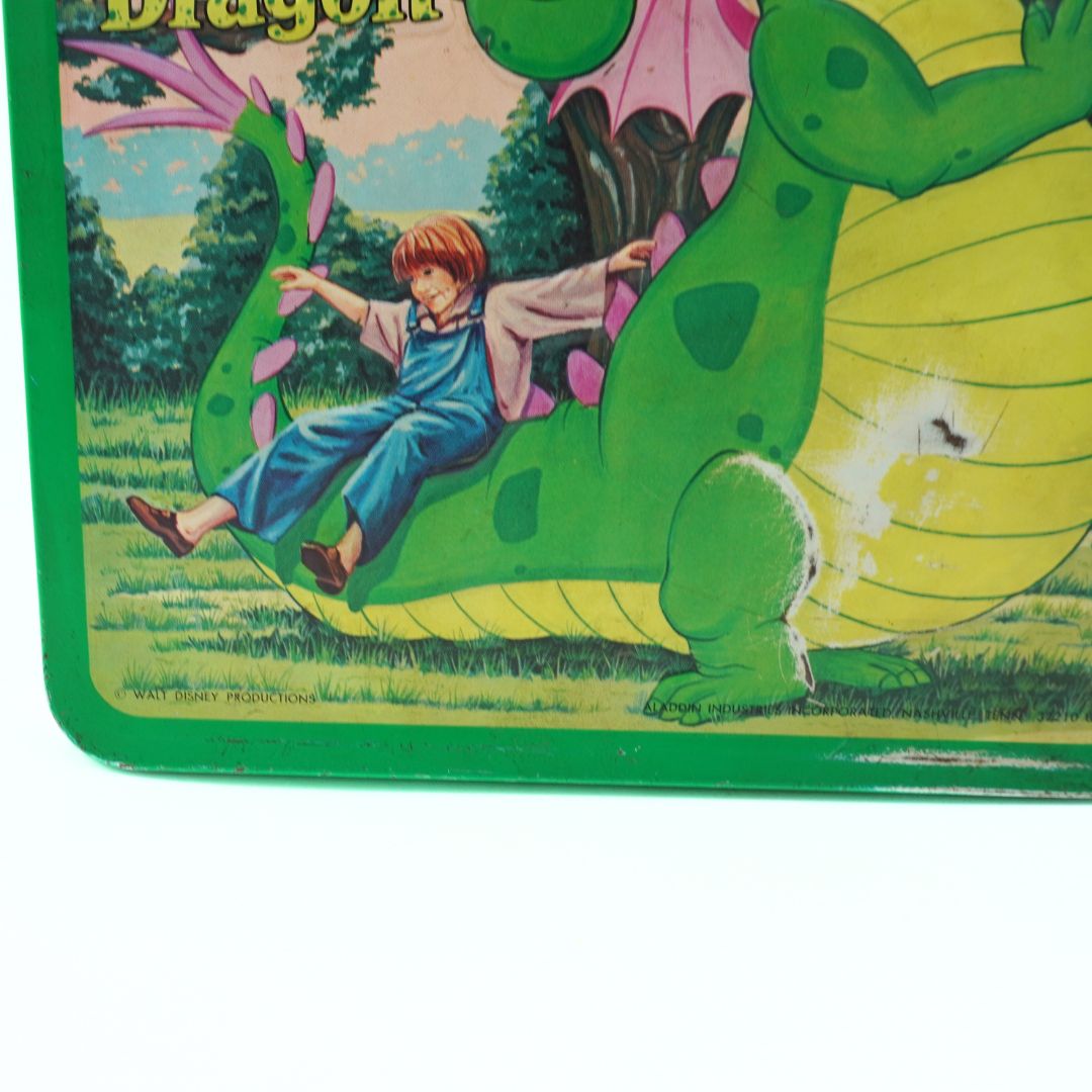 Vintage children's book cover with a boy riding a dragon in a green border