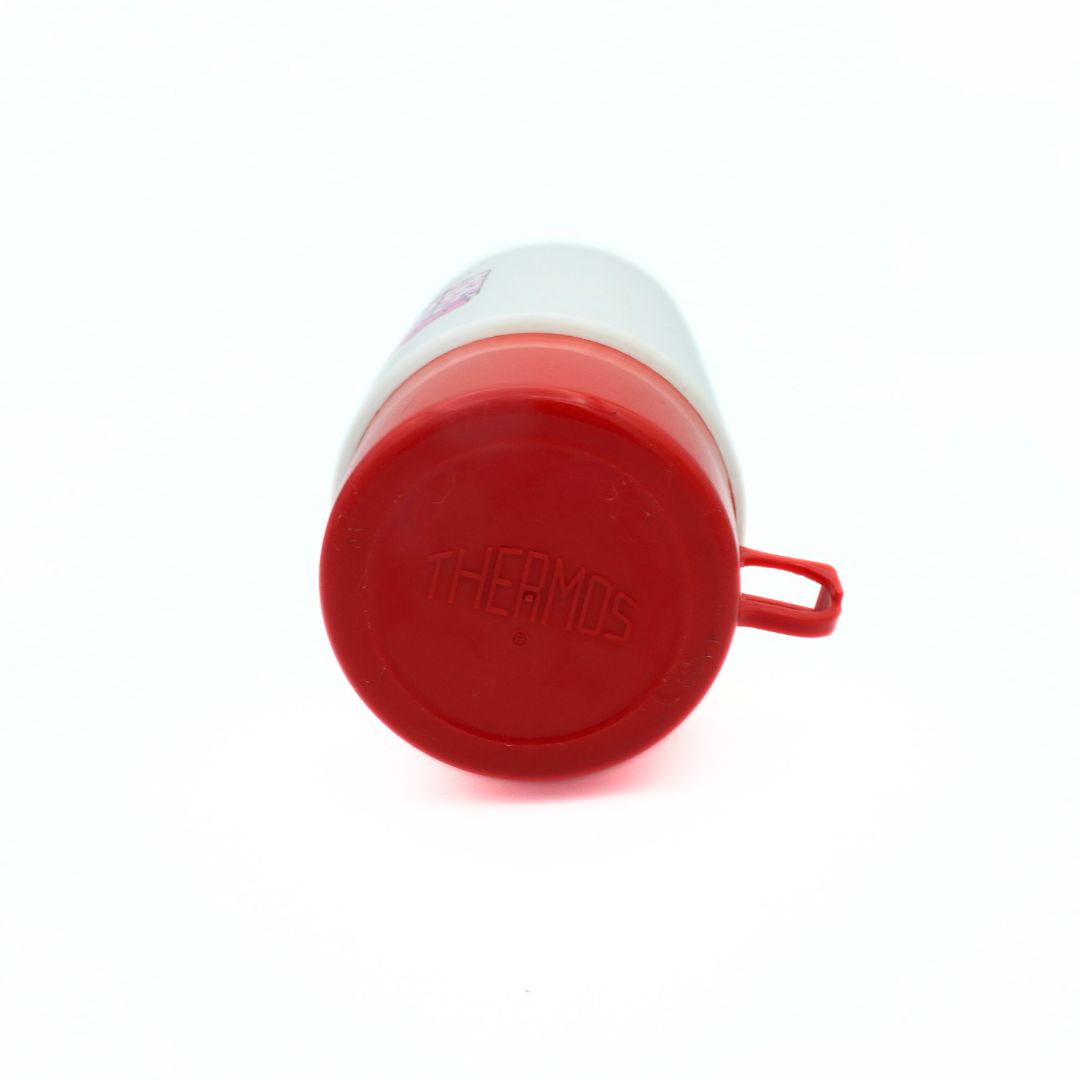 Top down photo of a 1990 Barbie Thermos with a replacement red lid