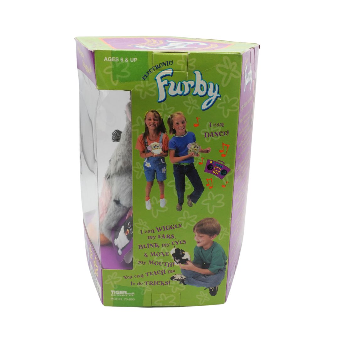Box of a Furby toy with green and purple design, featuring images of children playing with the toy.