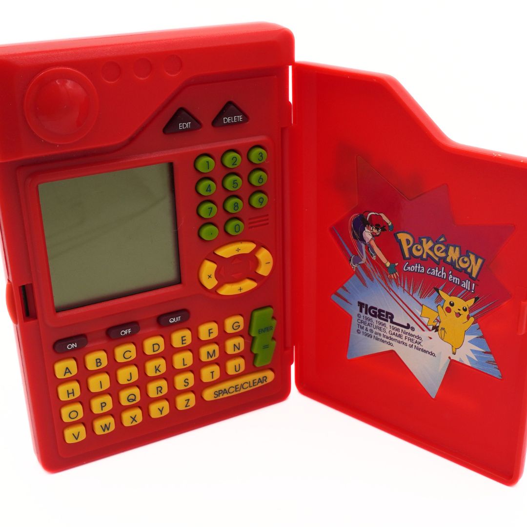Red toy electronic device with a screen and keyboard, featuring a Pokémon-themed cover.