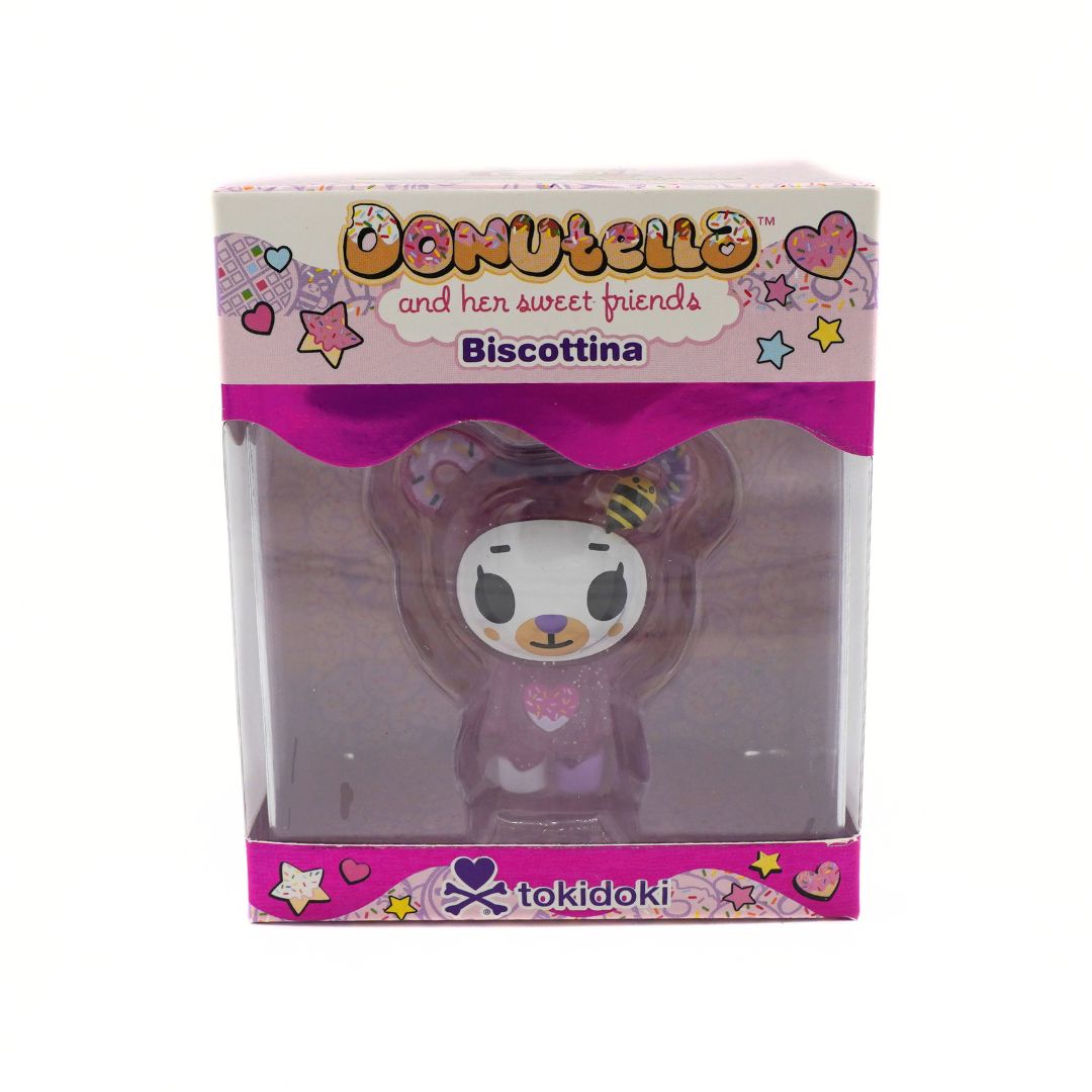 Tokidoki Biscottina figure in its original packaging, featuring a cute bear character inside a clear plastic box with a pink and white branded cardboard header.