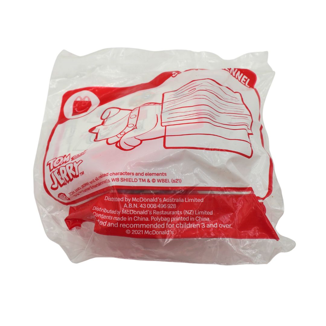 A sealed McDonald's Tom and Jerry Toy, containing a plastic bag with red printed graphics and text on a white background.