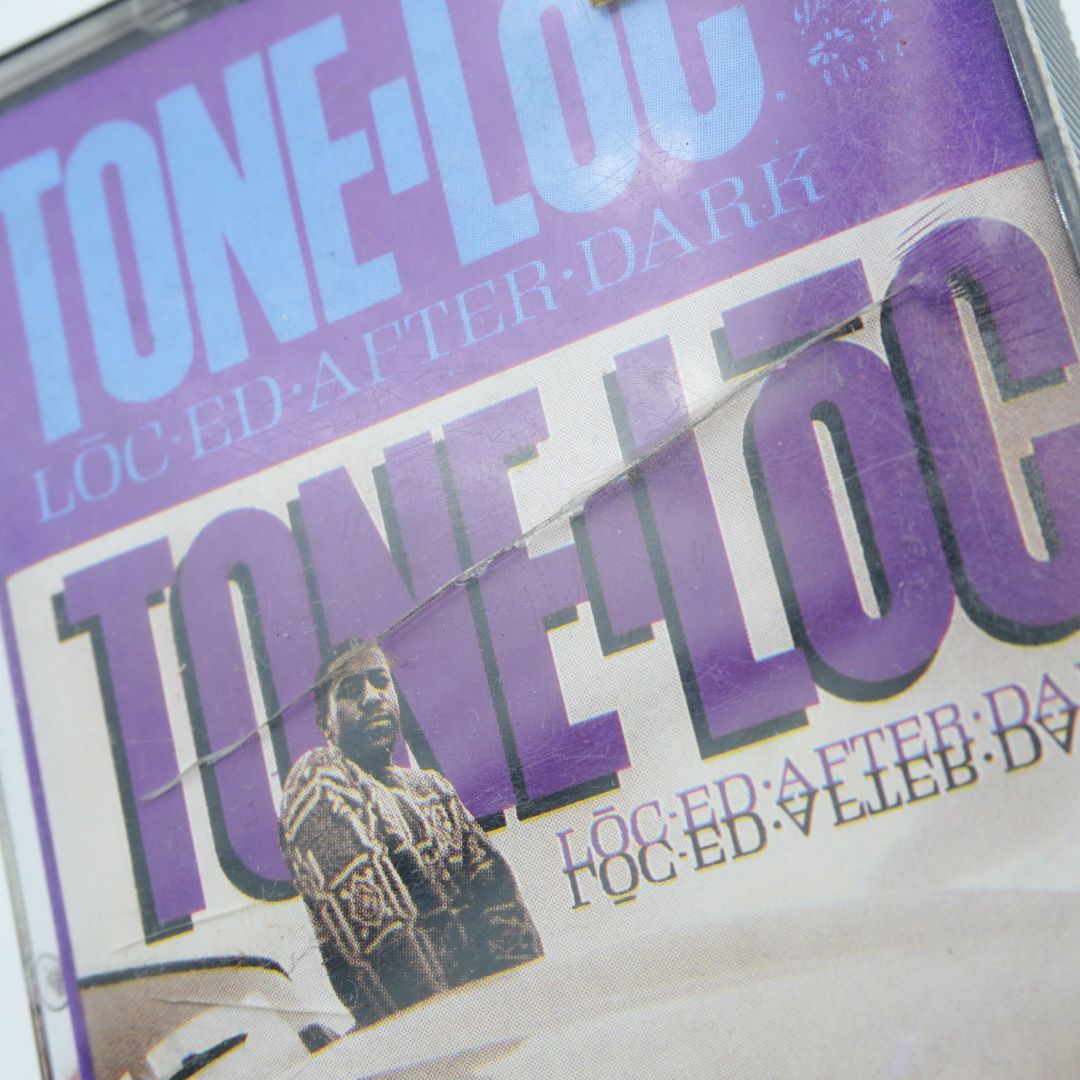 Close up of a purple plastic cassette case showing a crack across the front