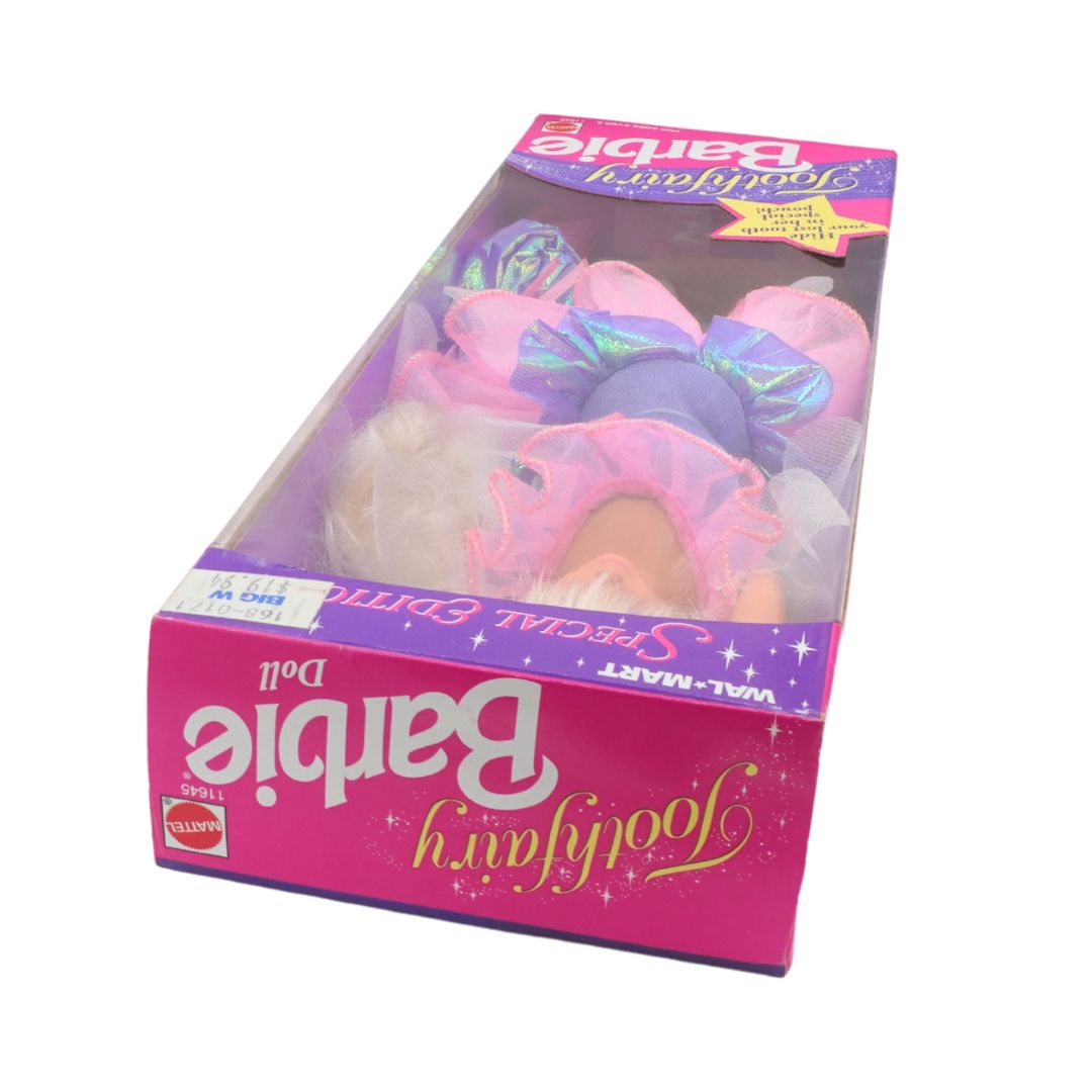 Barbie toy in packaging with colorful hair accessories on a white background