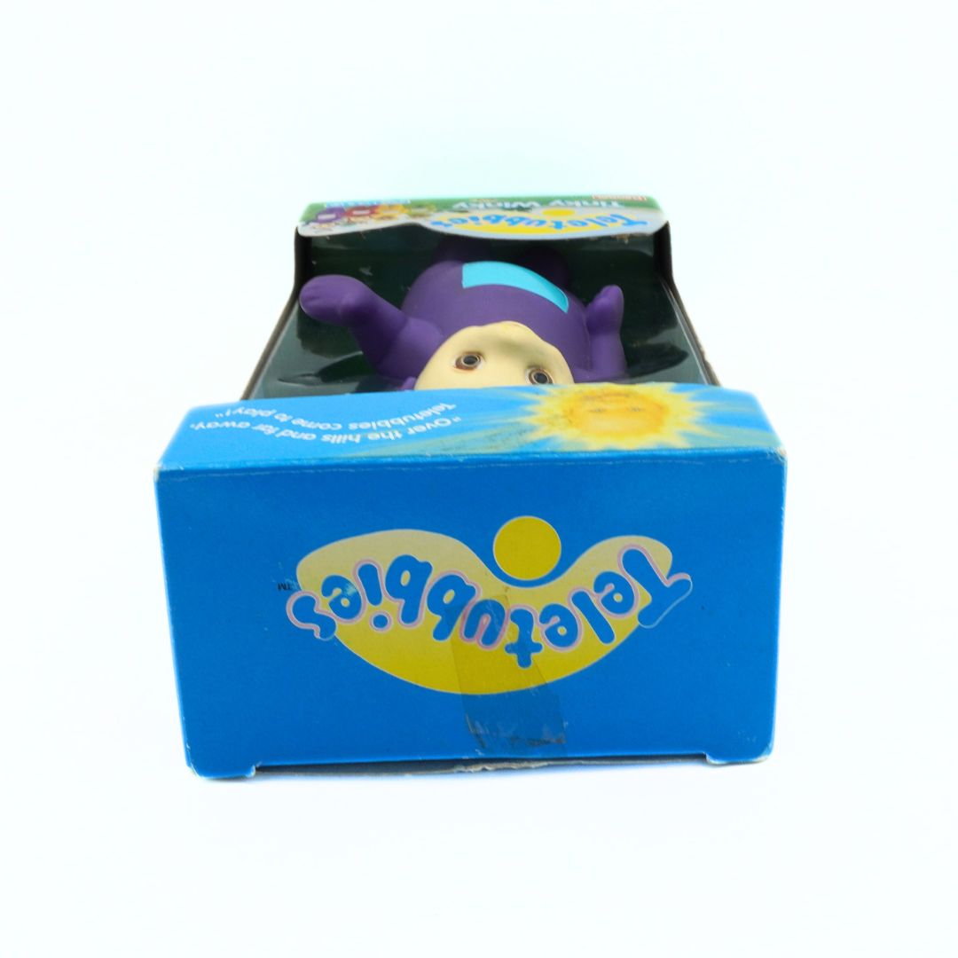 Purple toy figure in a blue box with 'Teletubbies' branding on a white background