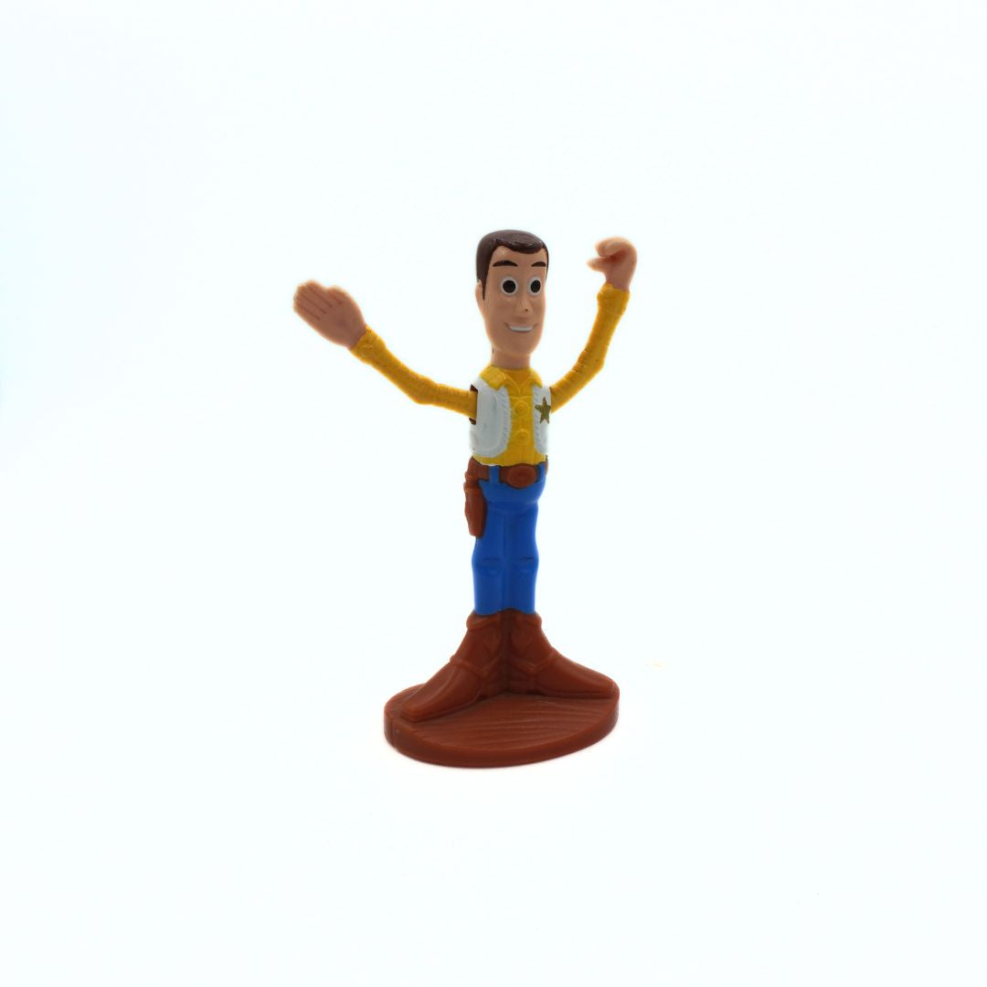 Toy figure of a character with a yellow shirt and blue pants on a white background