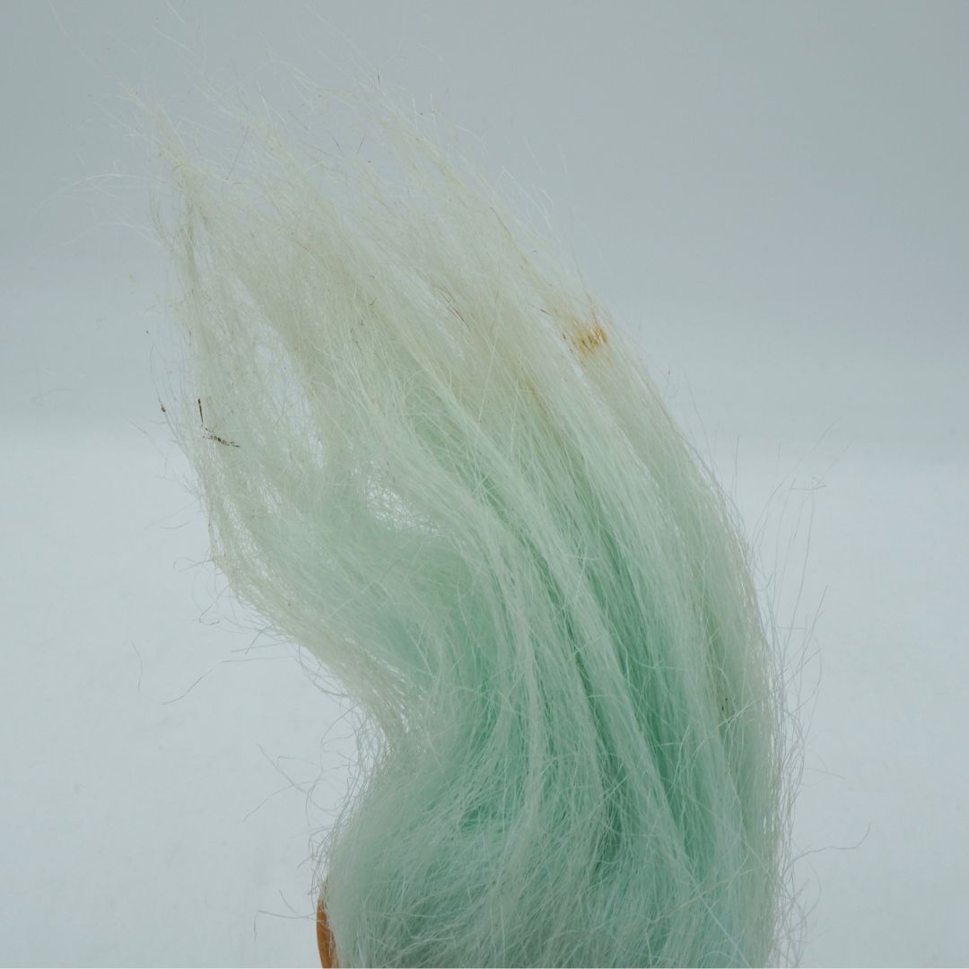 Close-up of green synthetic hair on a white background