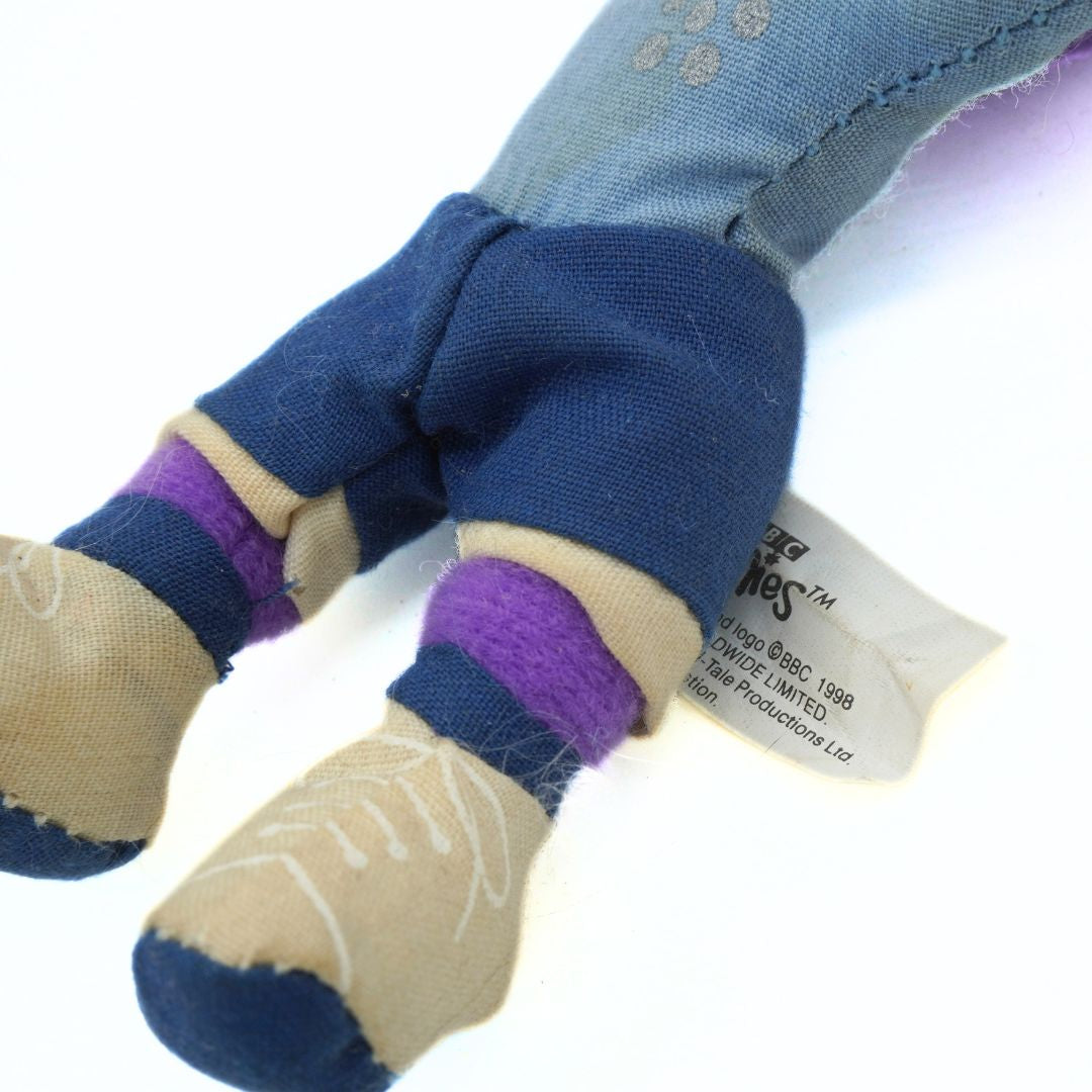 Close-up of a plush toy with a visible brand label on a white background