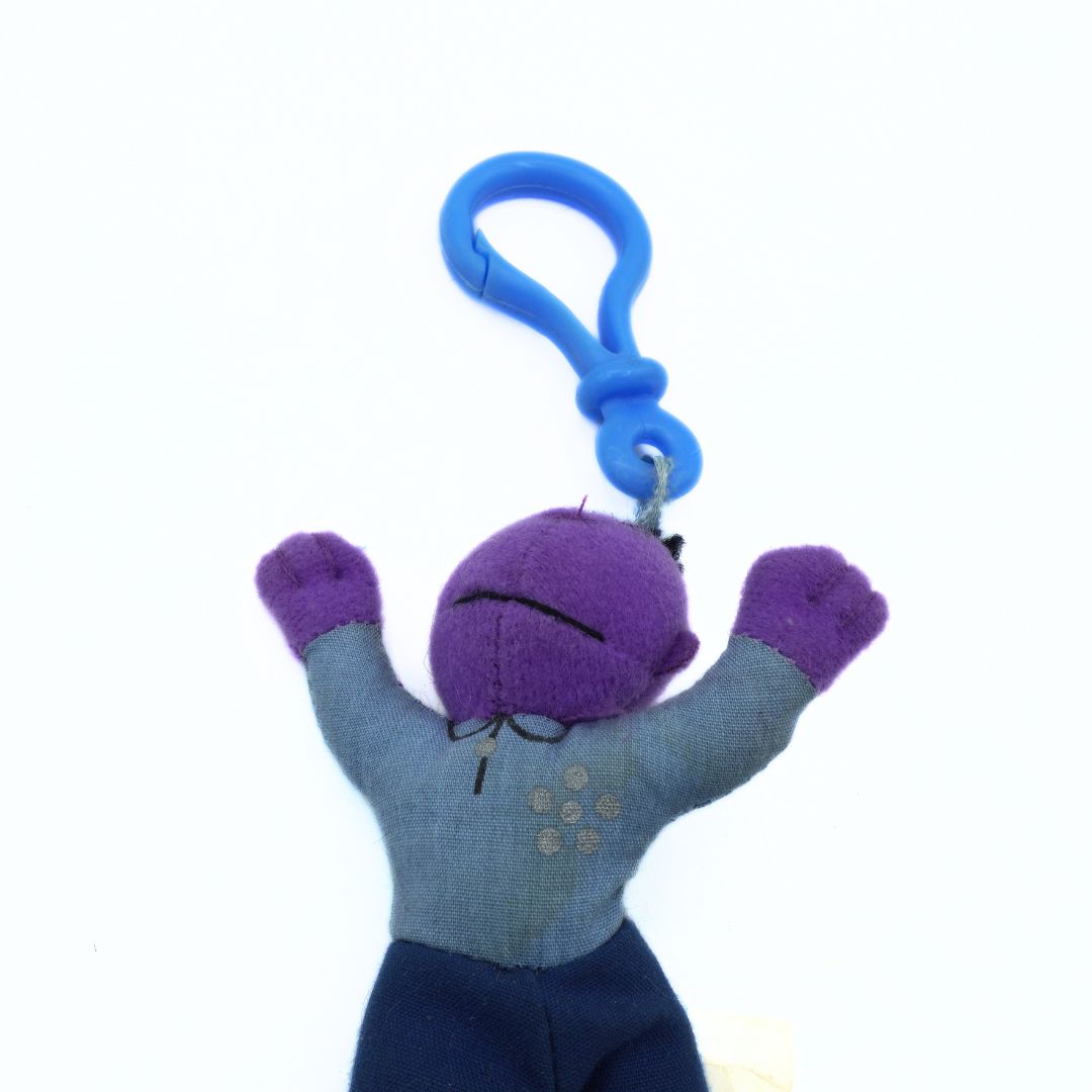 Plush keychain with a purple face and blue body on a white background