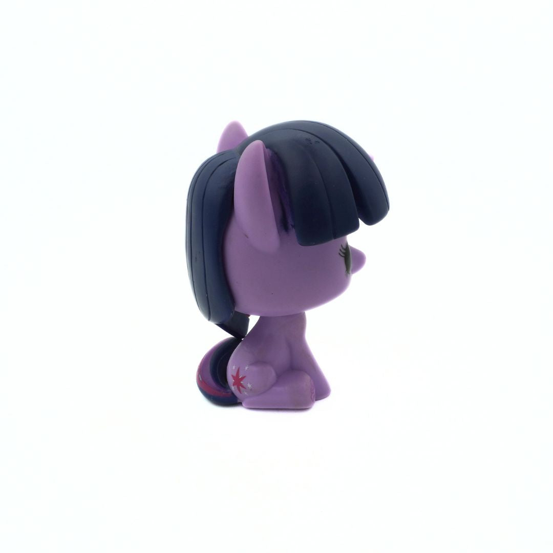 Side on photo of a vintage 2013 My Little Pony purple Funko Pop