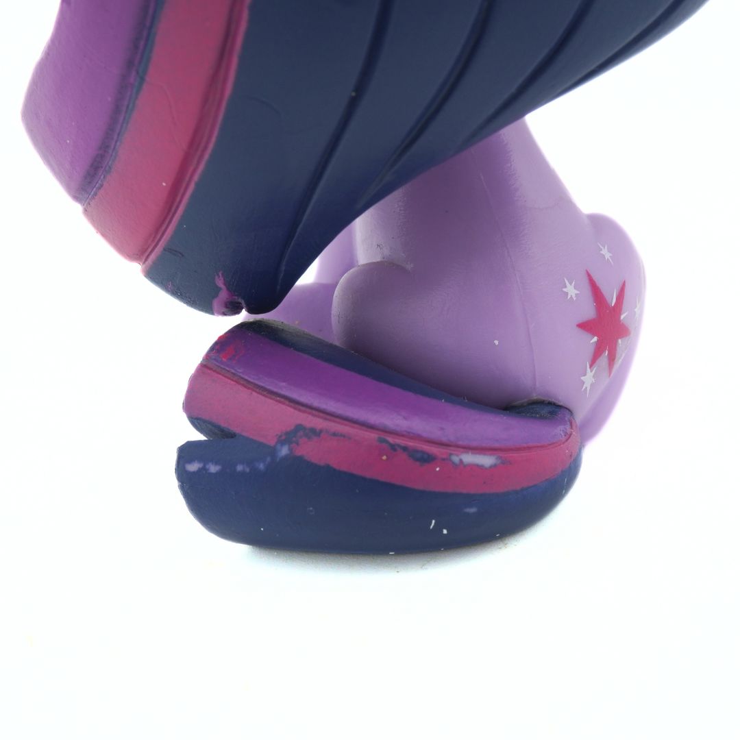 Damage and paint chipping to a purple and pink purple toy