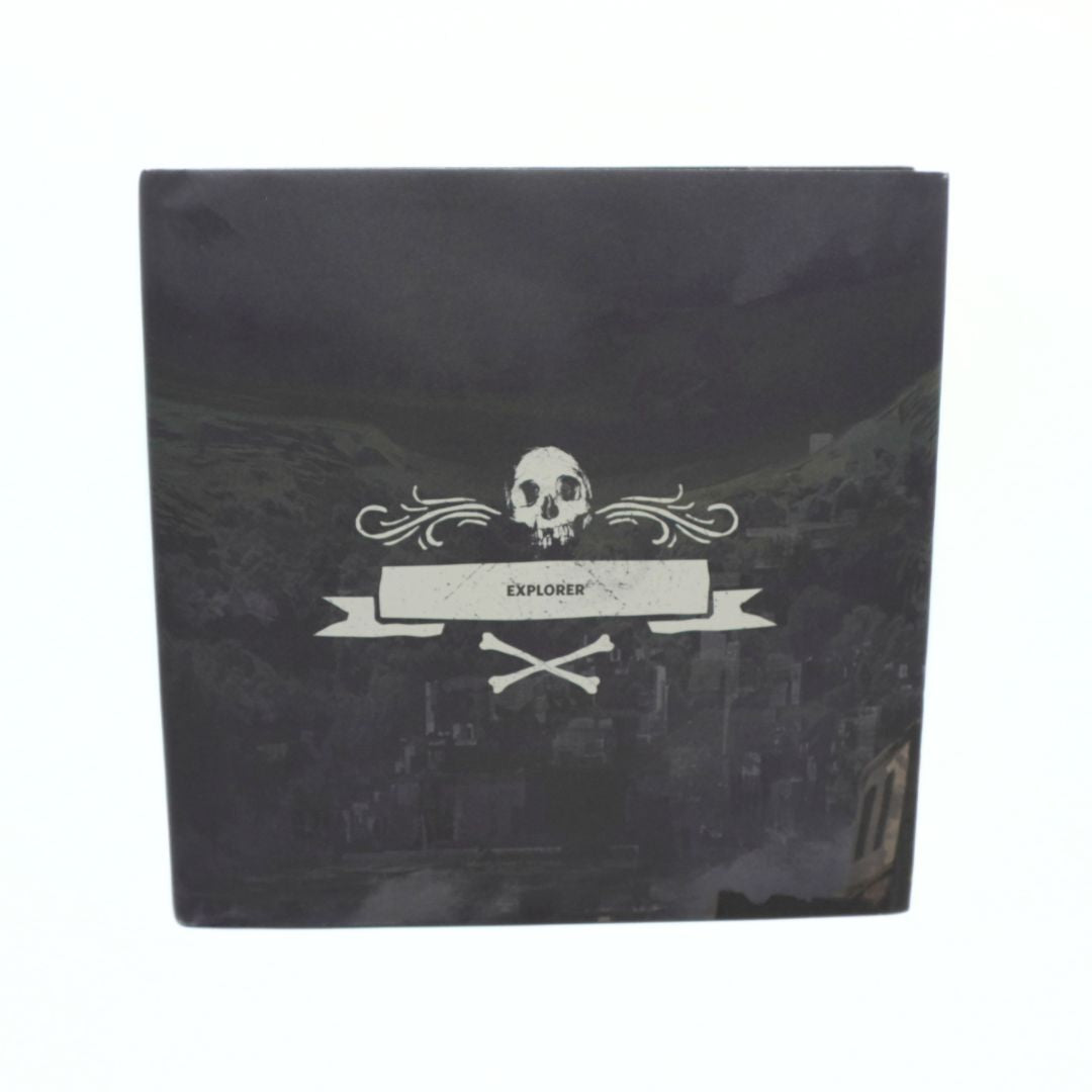 A square black box featuring a white skull and banner graphic with the word 'EXPLORER' on a dark scenic background, photographed against a plain white backdrop.