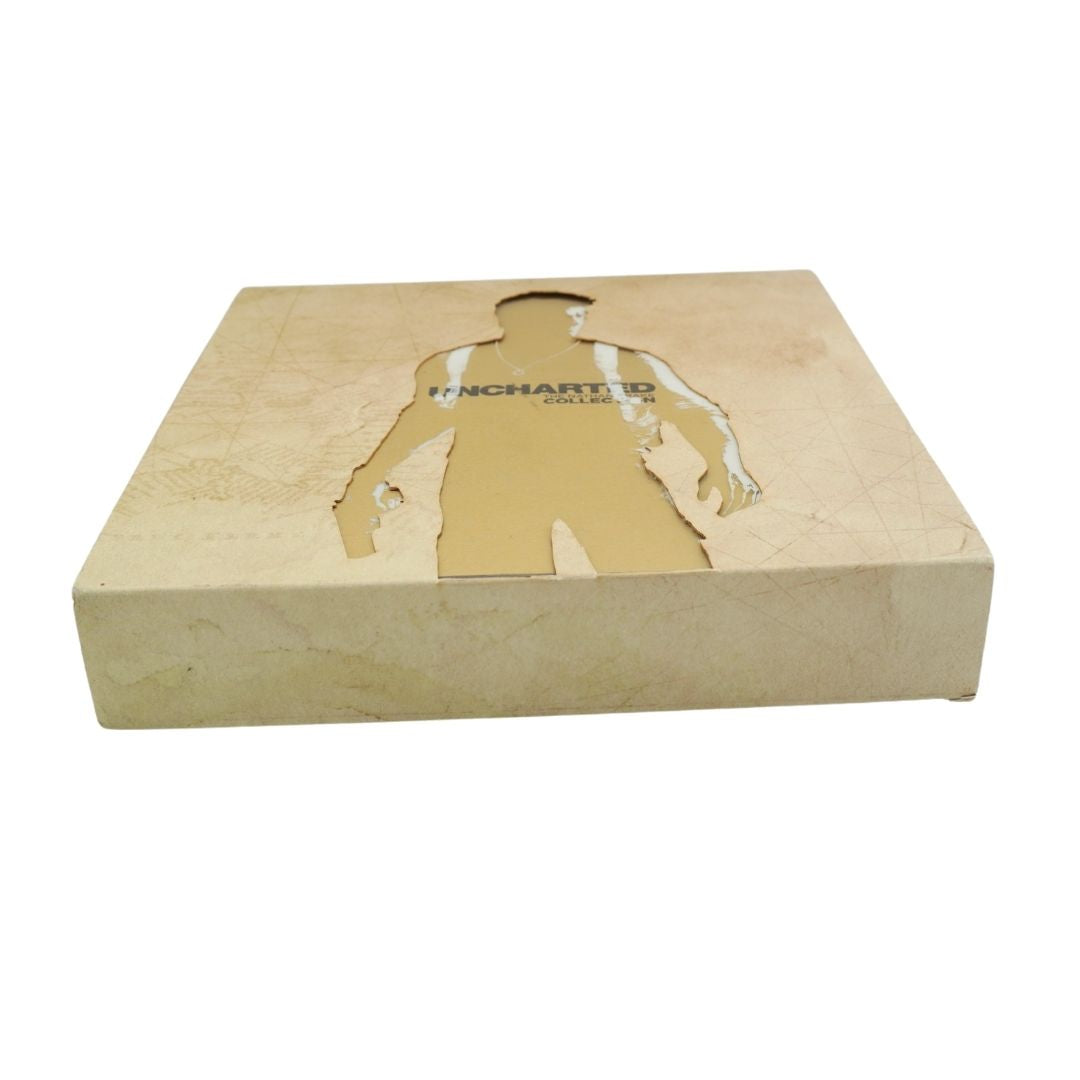A square beige cardboard display box with a cutout silhouette of a person on top, featuring the text 'UNCHARTED' printed on the front, set against a plain white background.