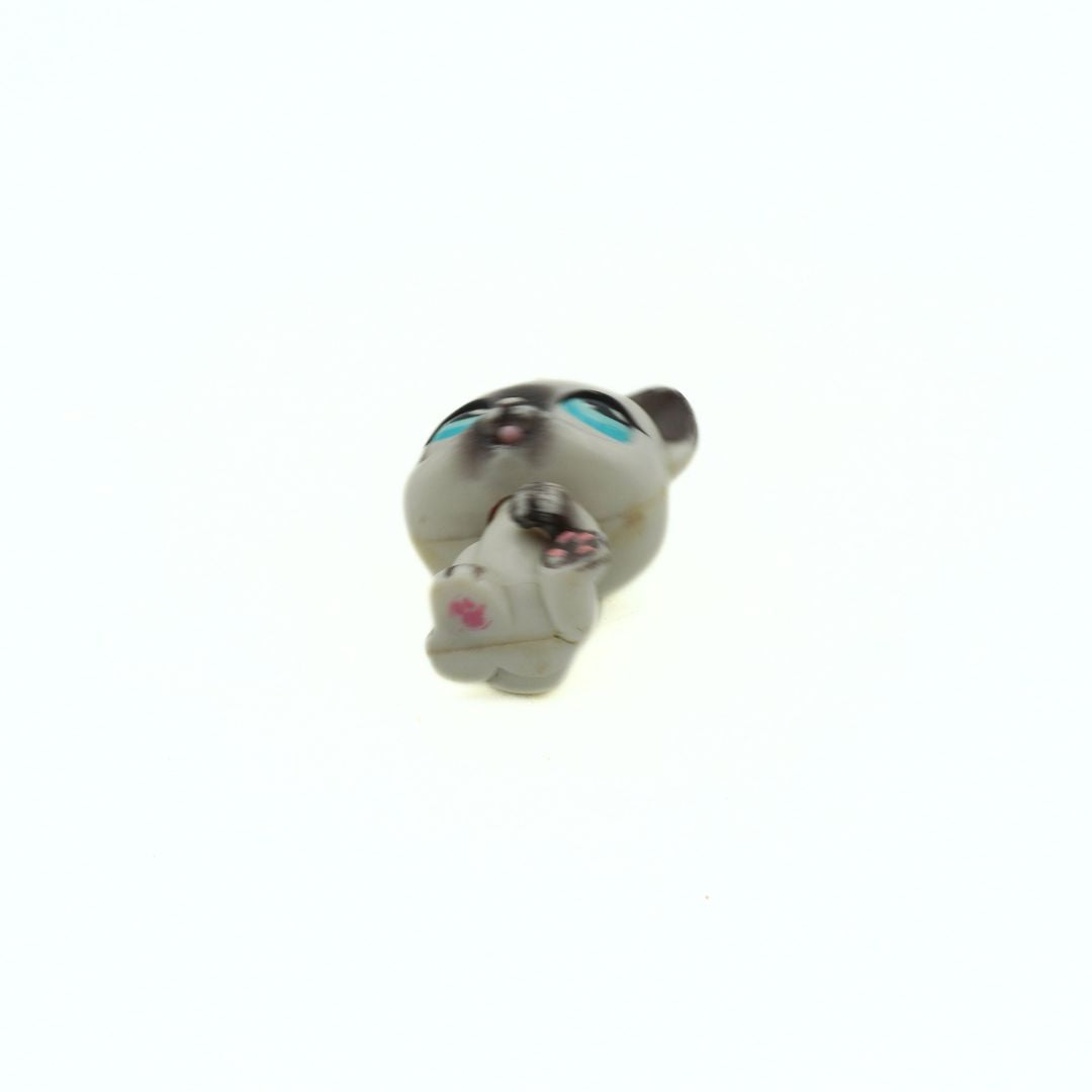 Toy figure of a character with a white face and black hair on a white background