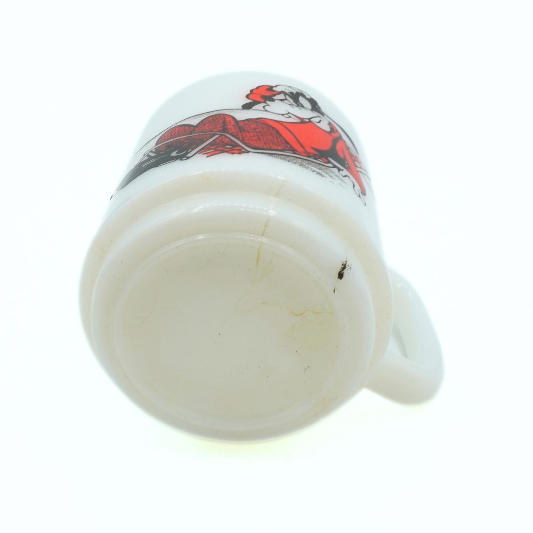 White mug with red and black design on a white background