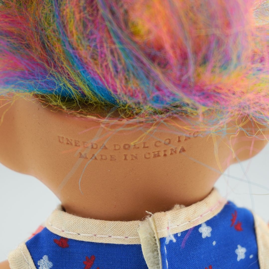 Branding to the back of an 80's Troll Doll showing the Uneeda branding and made in China stamp