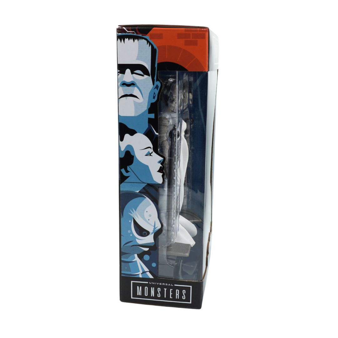 A boxed collectible featuring Universal monsters on the packaging, with doll pen inside.