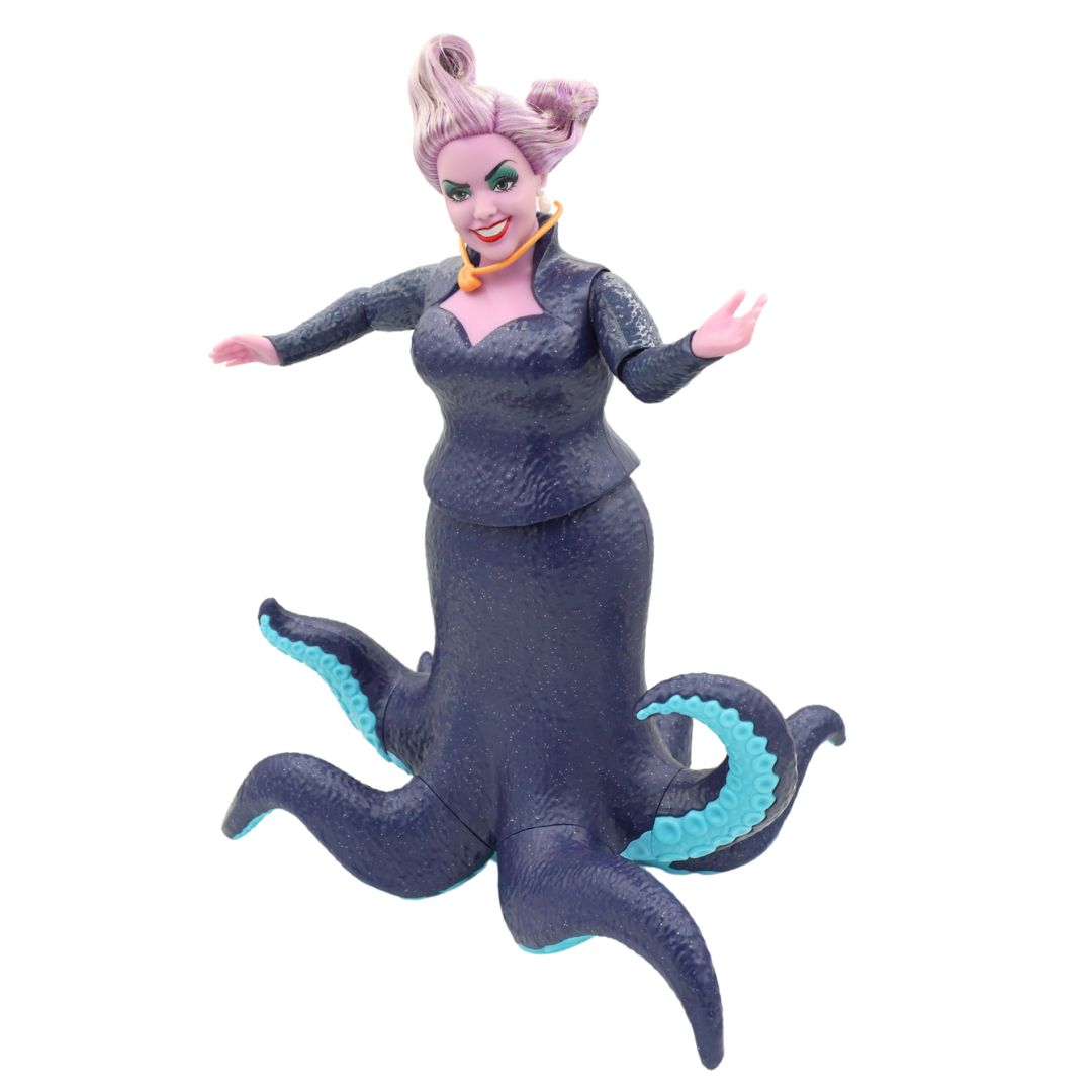 Ursula doll wearing a dark blue dress and with purple hair