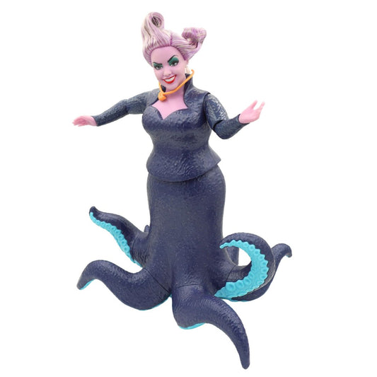 Ursula doll wearing a dark blue dress and with purple hair