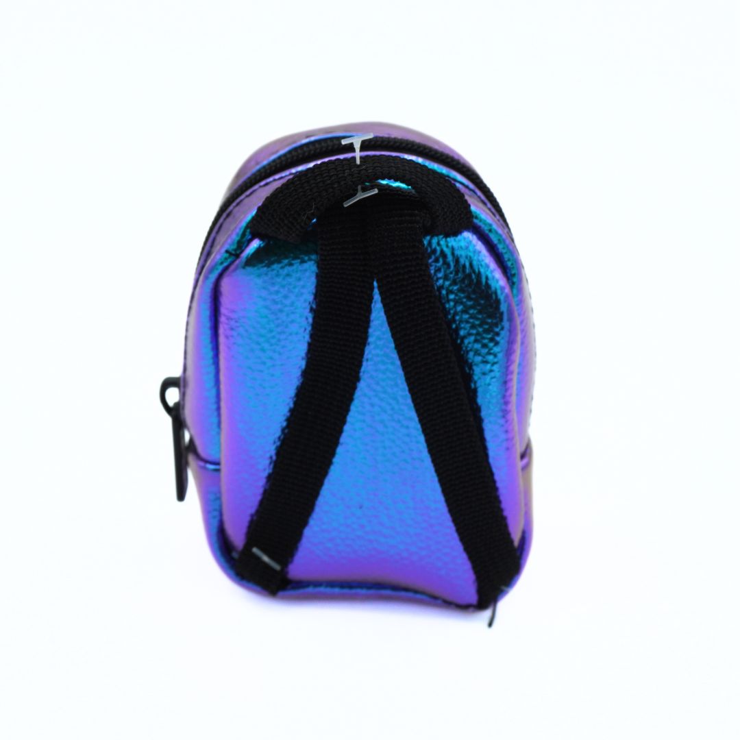 An iridescent holographic mini backpack with a textured finish, black zipper, and black shoulder straps, shown against a plain white background.