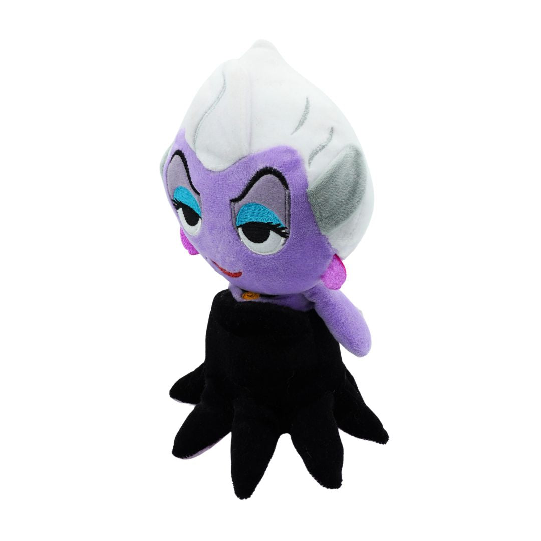 Plush toy of a character with purple skin, white hair, and black outfit on a white background