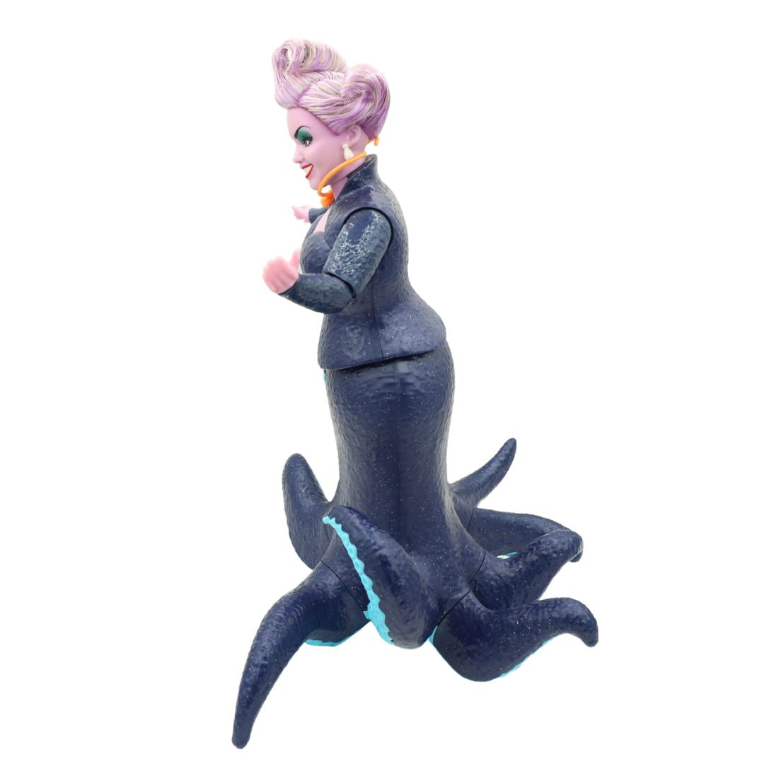 Ursula doll wearing a dark blue dress and with purple hair
