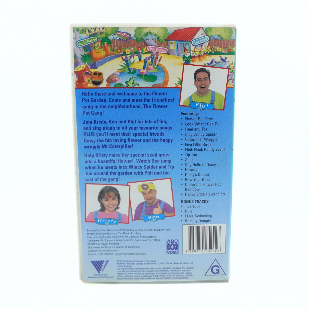 Back cover of a children's VHS video case for 'The Flower Pot Gang' featuring colorful cartoon illustrations, a blue background, character photos of Krissy and Phil, and a tracklist on the right.
