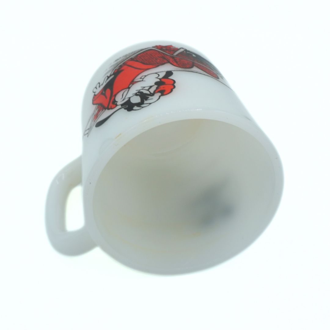 White mug with a red and black design on a white background