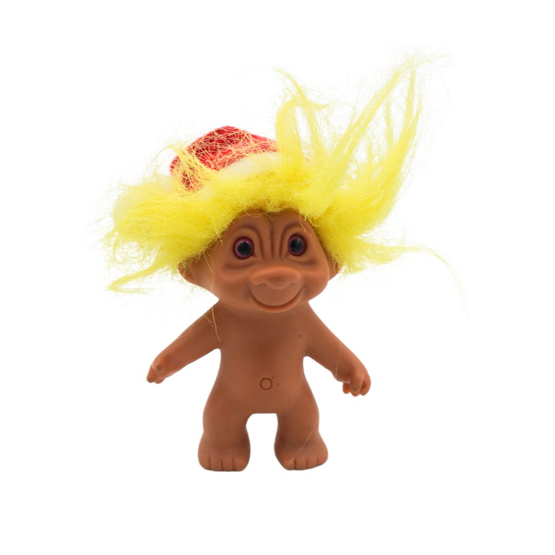 Toy figure with yellow hair and a red headband on a white background