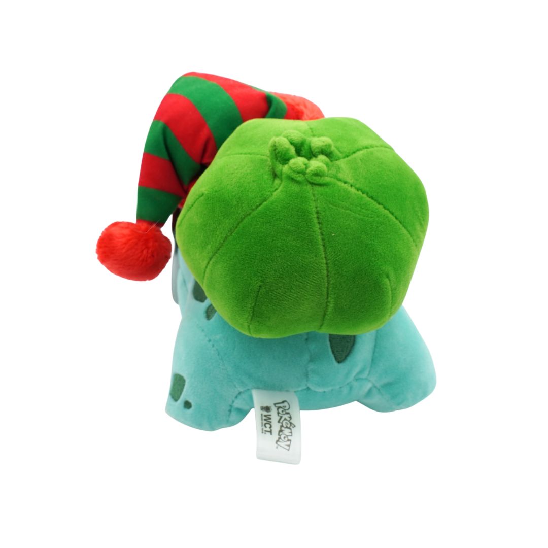 Green plush toy with a red and green striped hat on a white background