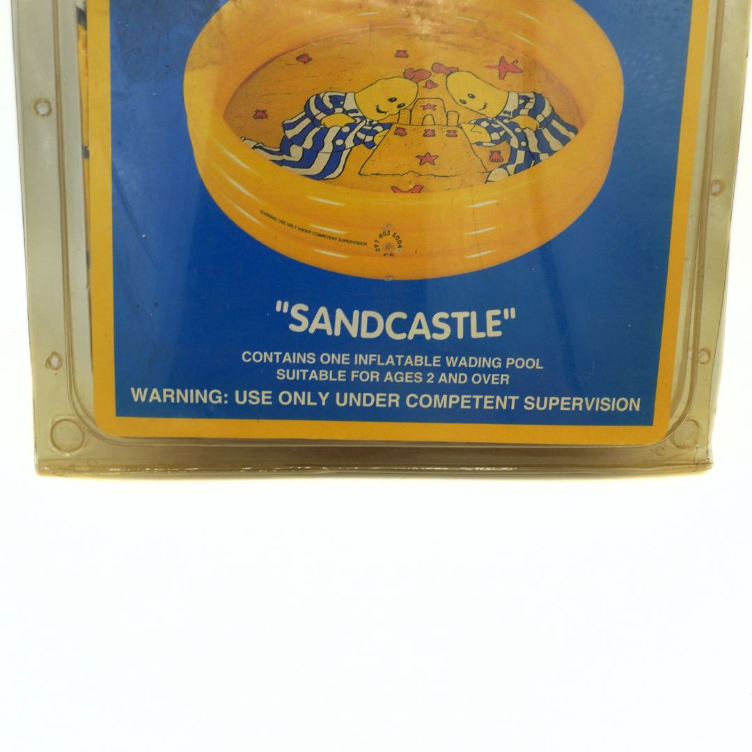 Inflatable wading pool packaging with 'Sandcastle' branding on a blue background