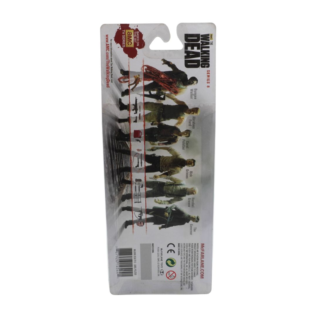 Packaged toy figures from 'The Walking Dead' series on a white background