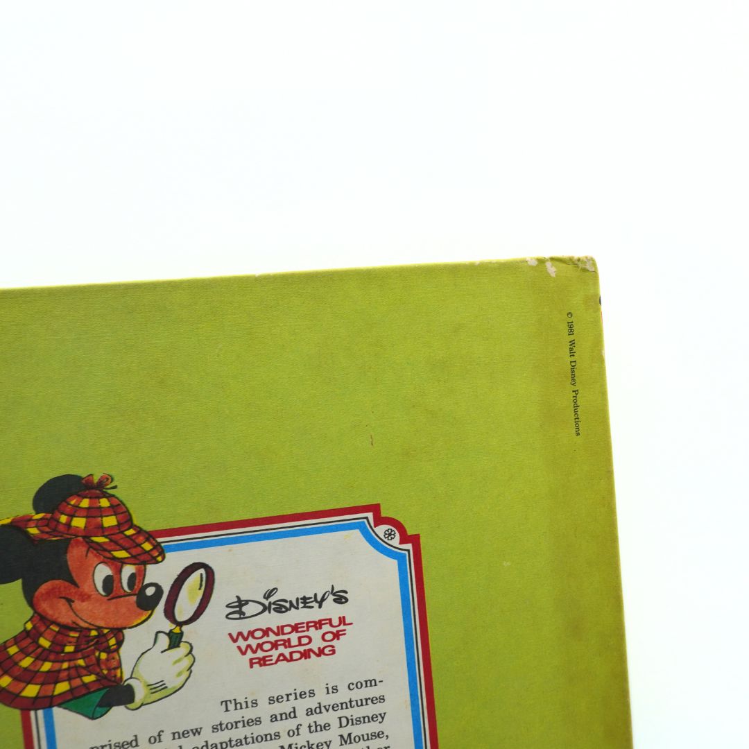 Vintage Disney book corner with character illustration and text on a green background