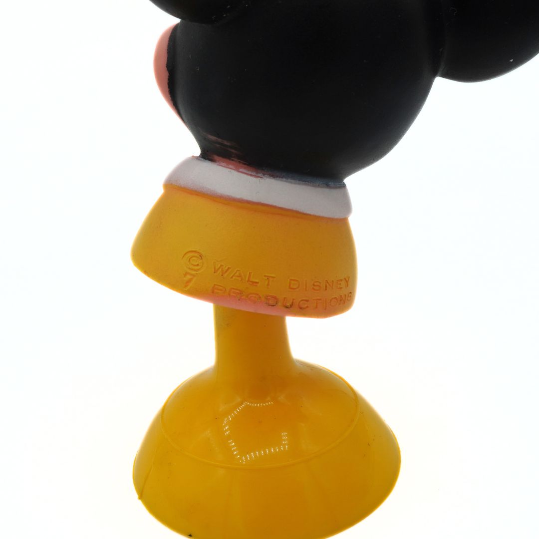 Yellow character with a black head on a white background