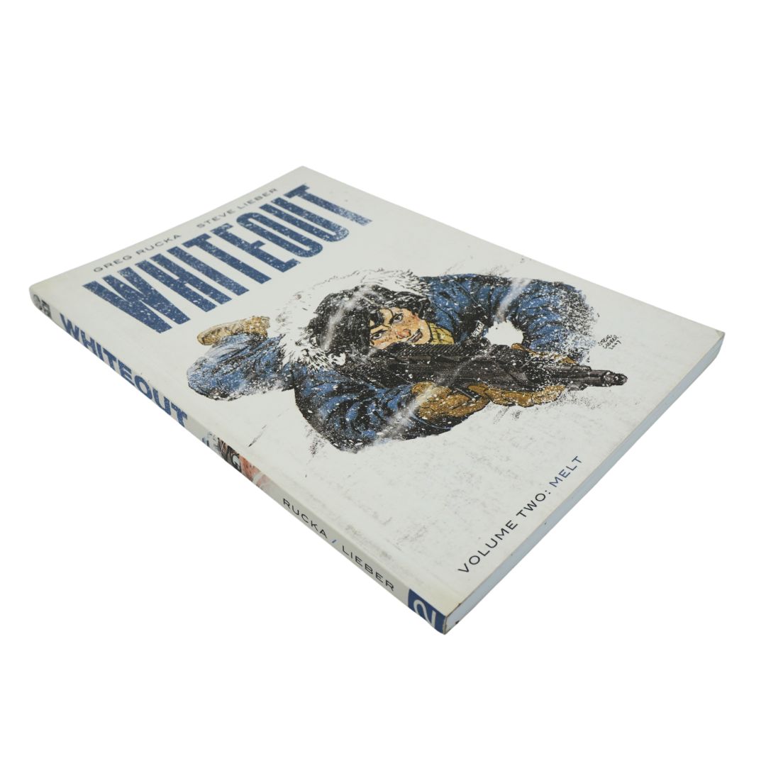 SIde on photo of a blue and white bound paperback book called Whiteout Volume Two: Melt